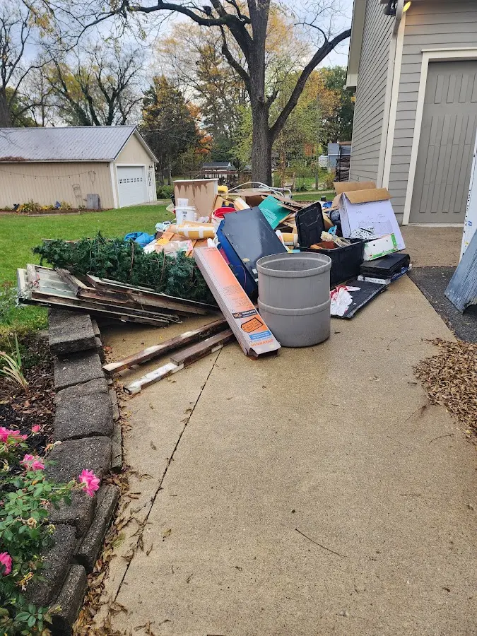 Dumpster being loaded with debris for 10 Yard Dumpster Rental in Nampa